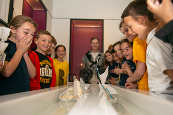 Students standing around a boat race.