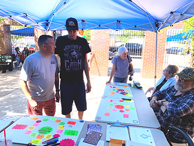 People gathering visit outdoor event table.