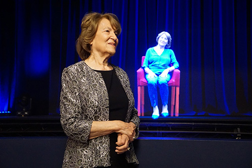 Woman standing in front of a museum exhibit.