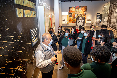 Museum docent exaplains exhibit to visitors.