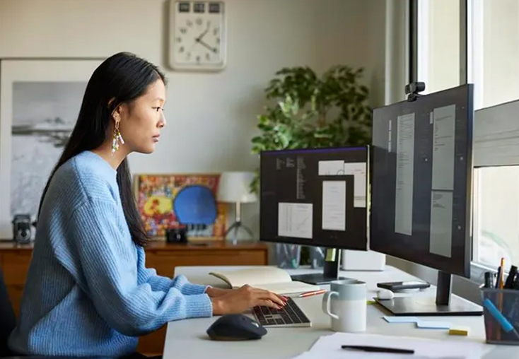 Asian woman and museum administrator at computer