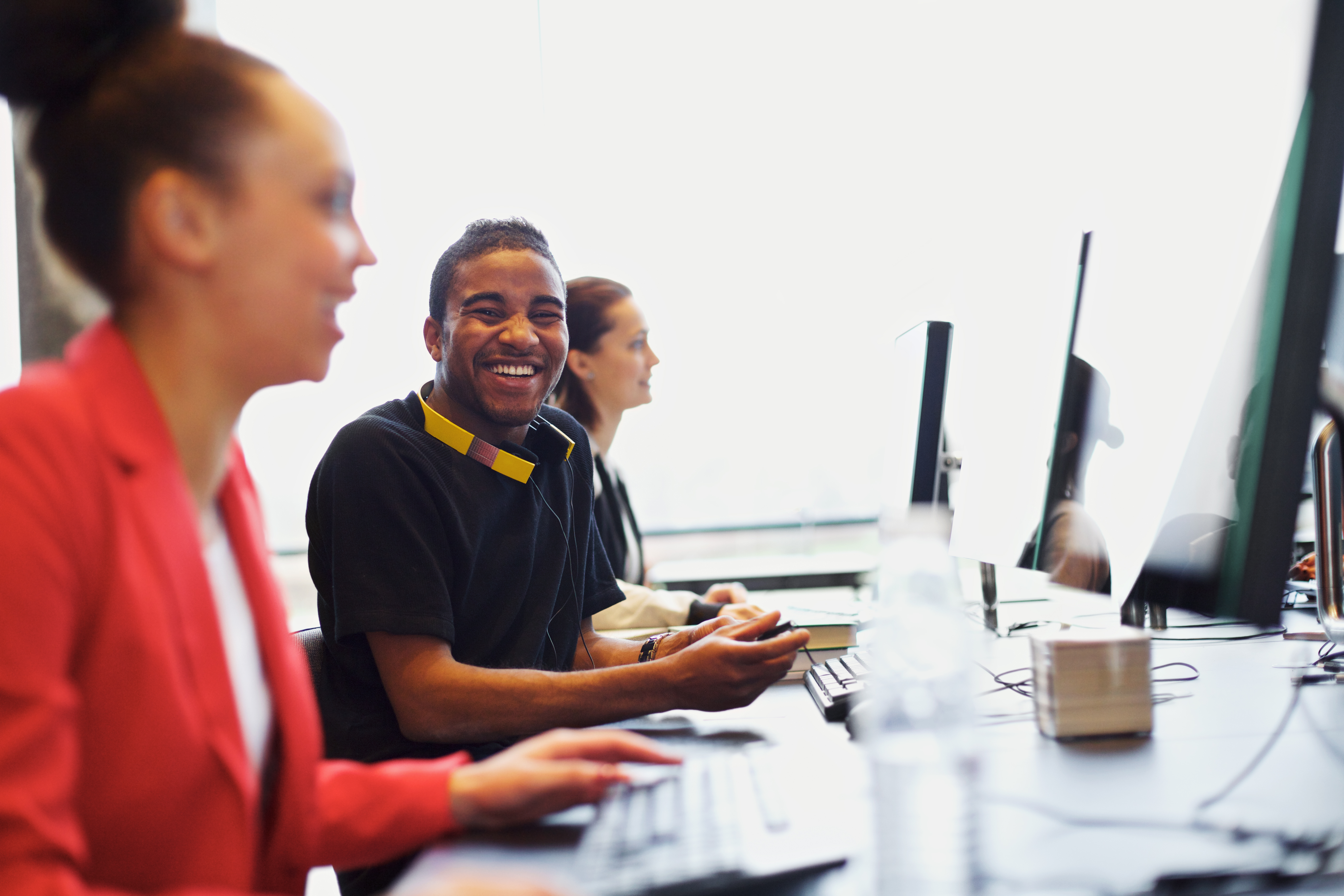 Young adults at computer laughing