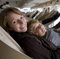 A family rests in the hammock, where a sailor in 1812 would have only slept for 4 hours at a time.