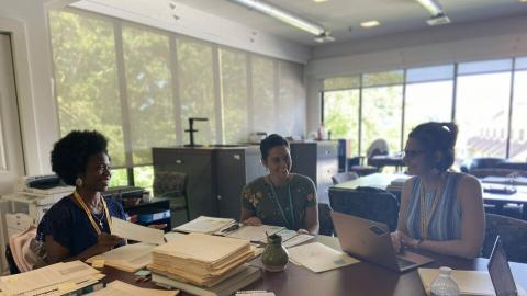 Summer interns sitting at table